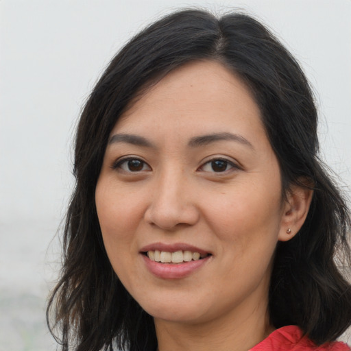 Joyful asian young-adult female with long  brown hair and brown eyes