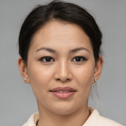 Joyful asian young-adult female with medium  brown hair and brown eyes