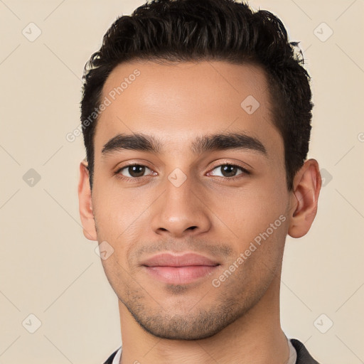 Joyful white young-adult male with short  black hair and brown eyes