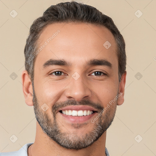 Joyful white young-adult male with short  black hair and brown eyes