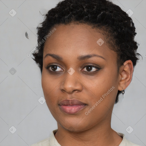 Joyful black young-adult female with short  black hair and brown eyes