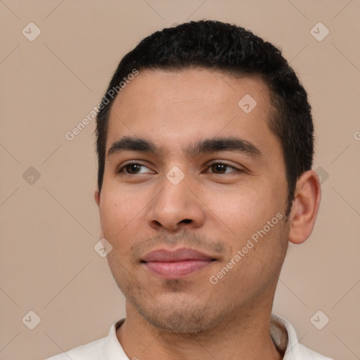 Joyful white young-adult male with short  black hair and brown eyes