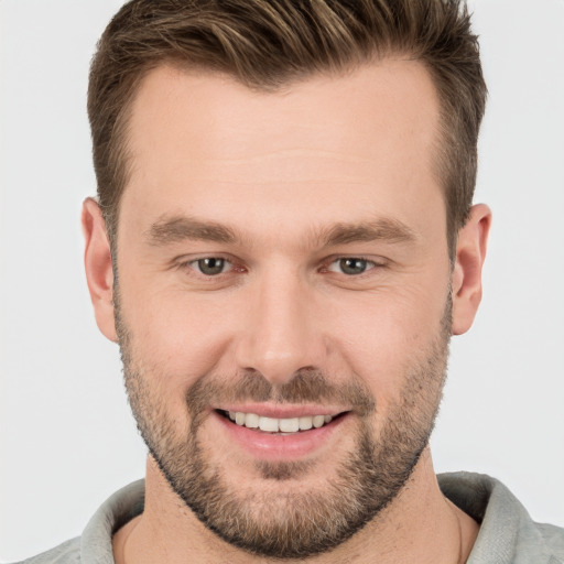 Joyful white young-adult male with short  brown hair and brown eyes