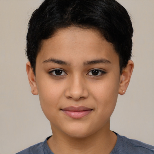 Joyful latino child female with short  brown hair and brown eyes