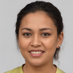 Joyful latino young-adult female with medium  brown hair and brown eyes