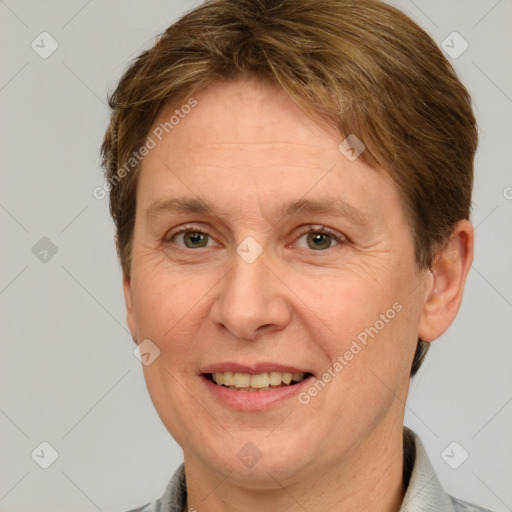 Joyful white adult female with short  brown hair and grey eyes