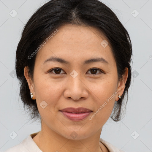 Joyful asian adult female with medium  brown hair and brown eyes