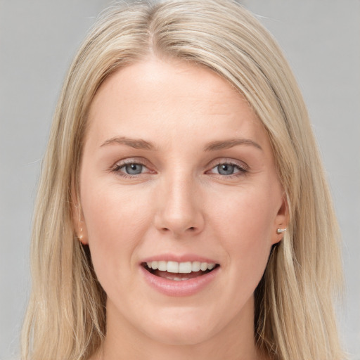 Joyful white young-adult female with long  brown hair and blue eyes