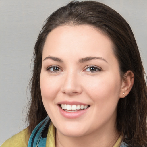 Joyful white young-adult female with medium  brown hair and brown eyes