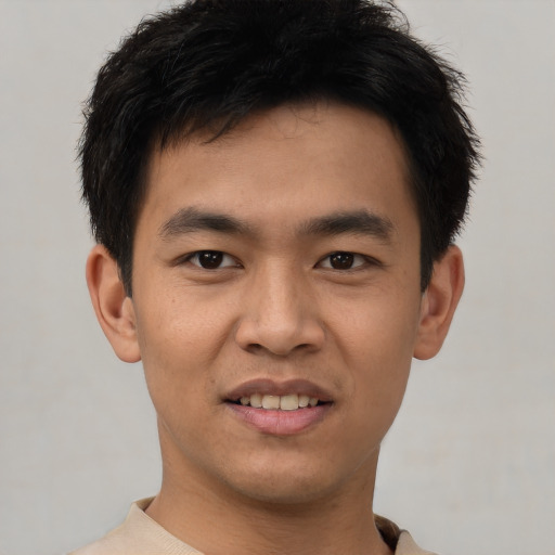 Joyful asian young-adult male with short  black hair and brown eyes