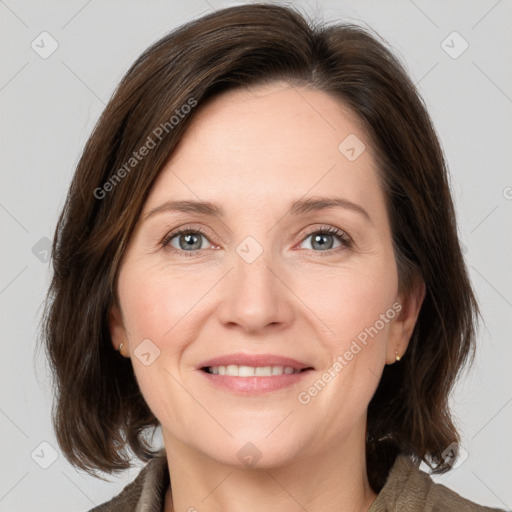 Joyful white adult female with medium  brown hair and green eyes