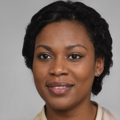 Joyful black young-adult female with medium  black hair and brown eyes