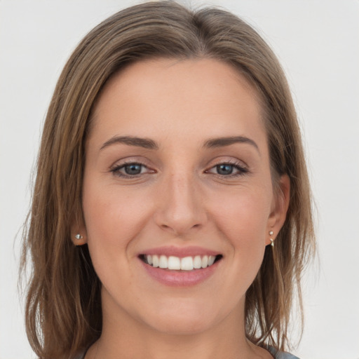 Joyful white young-adult female with medium  brown hair and grey eyes