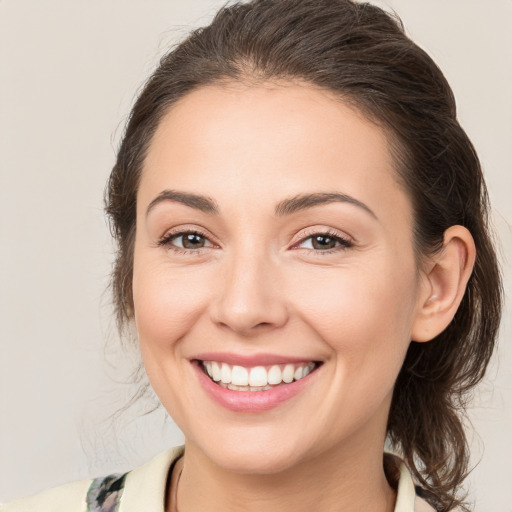 Joyful white young-adult female with medium  brown hair and brown eyes