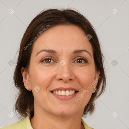 Joyful white adult female with medium  brown hair and grey eyes