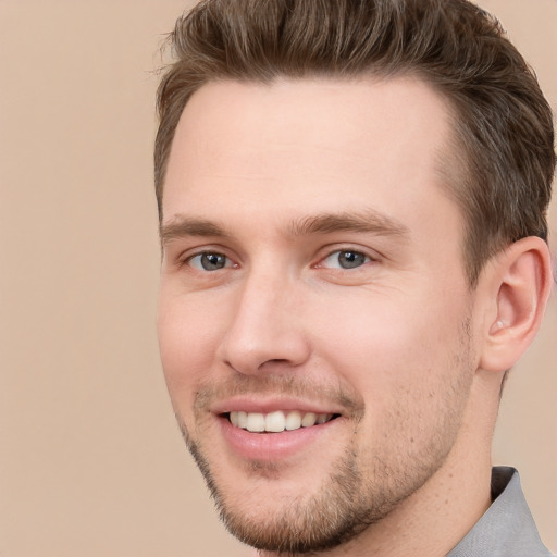 Joyful white young-adult male with short  brown hair and brown eyes