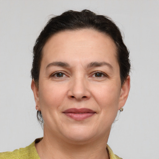 Joyful white adult female with short  brown hair and brown eyes