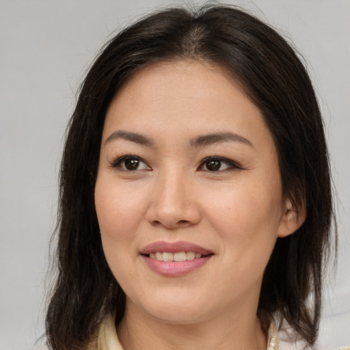 Joyful asian young-adult female with medium  brown hair and brown eyes