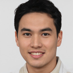 Joyful asian young-adult male with short  brown hair and brown eyes