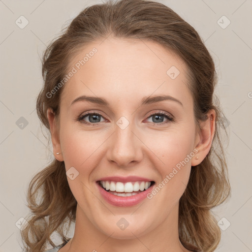 Joyful white young-adult female with long  brown hair and blue eyes