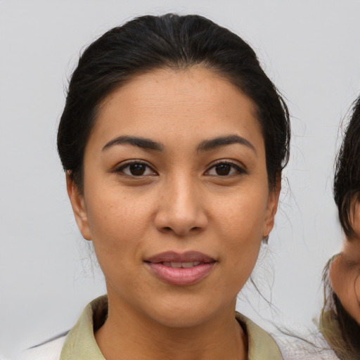 Joyful latino young-adult female with medium  brown hair and brown eyes