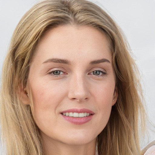 Joyful white young-adult female with long  brown hair and blue eyes