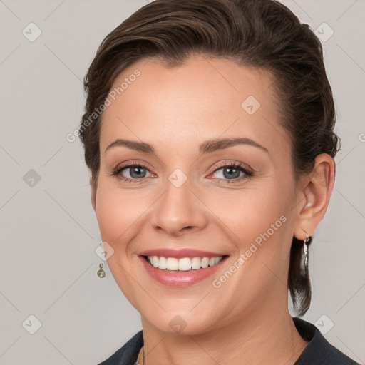 Joyful white young-adult female with medium  brown hair and grey eyes