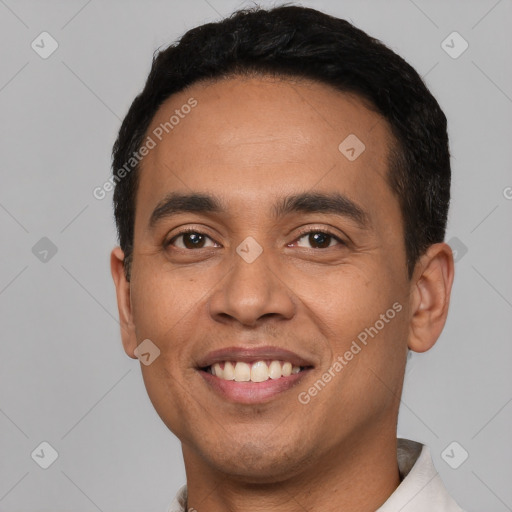 Joyful latino young-adult male with short  black hair and brown eyes