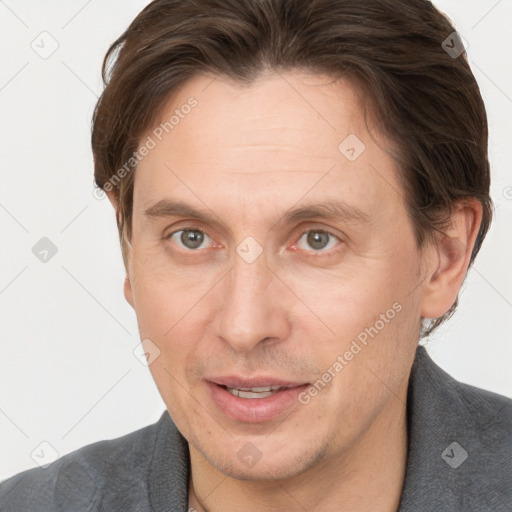 Joyful white adult male with short  brown hair and grey eyes