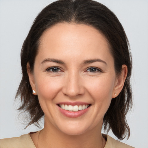 Joyful white young-adult female with medium  brown hair and brown eyes