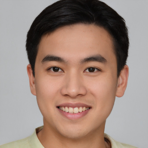 Joyful asian young-adult male with short  brown hair and brown eyes