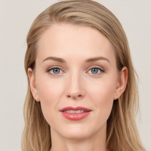 Joyful white young-adult female with long  brown hair and blue eyes