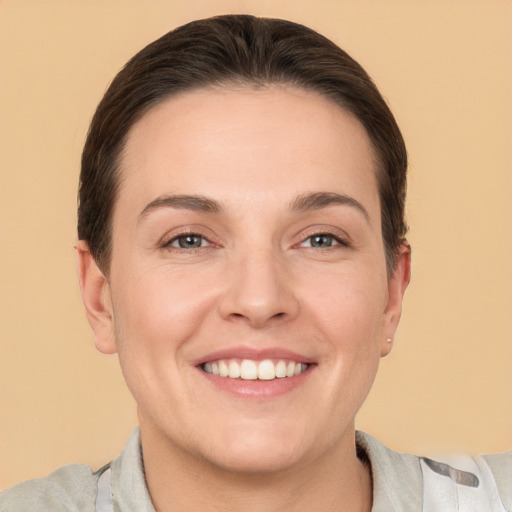 Joyful white young-adult female with short  brown hair and brown eyes