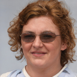 Joyful white young-adult female with medium  brown hair and blue eyes