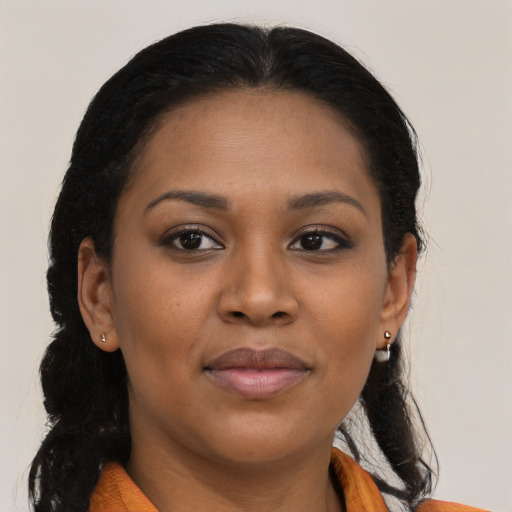 Joyful black young-adult female with long  brown hair and brown eyes