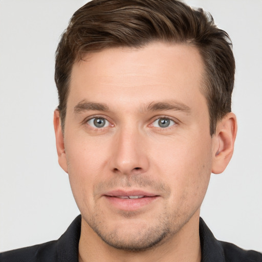 Joyful white young-adult male with short  brown hair and grey eyes