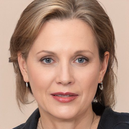 Joyful white adult female with medium  brown hair and grey eyes