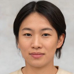 Joyful asian young-adult female with medium  brown hair and brown eyes