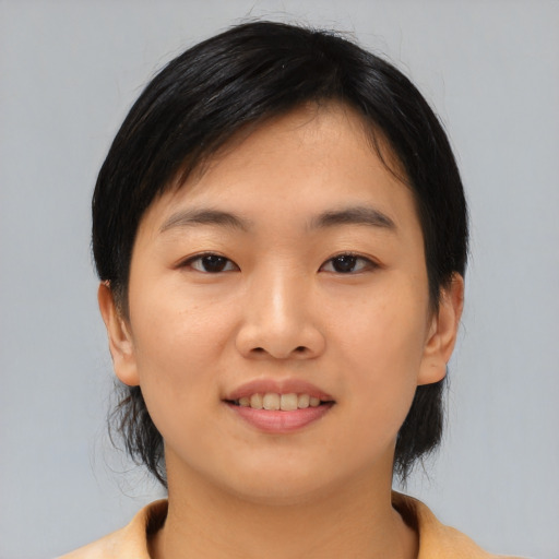 Joyful asian young-adult female with medium  black hair and brown eyes