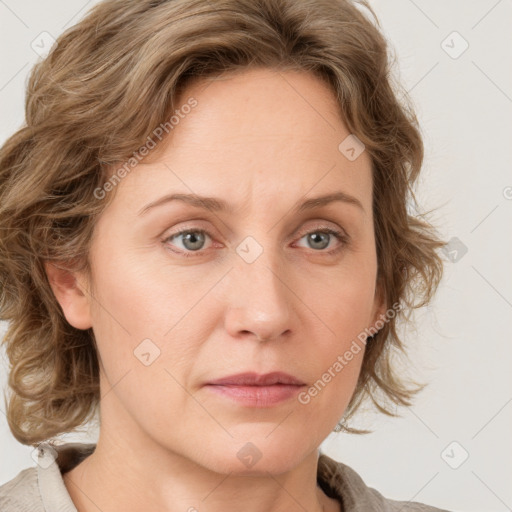 Joyful white adult female with medium  brown hair and blue eyes