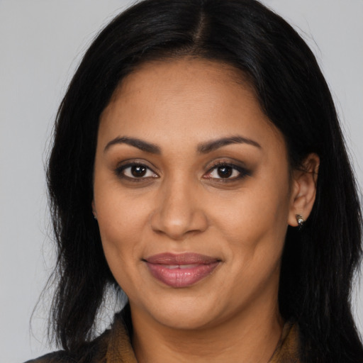 Joyful latino adult female with long  brown hair and brown eyes