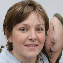 Joyful white young-adult female with medium  brown hair and blue eyes