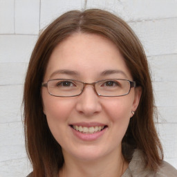 Joyful white young-adult female with medium  brown hair and grey eyes