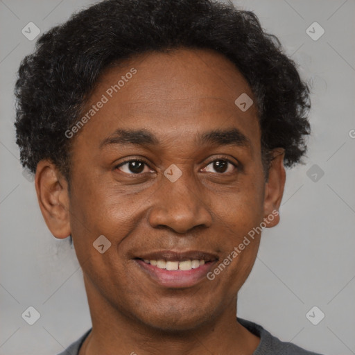 Joyful black adult male with short  brown hair and brown eyes