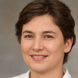 Joyful white young-adult female with medium  brown hair and brown eyes