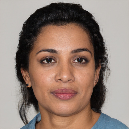 Joyful latino young-adult female with medium  black hair and brown eyes