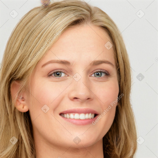 Joyful white young-adult female with long  brown hair and blue eyes