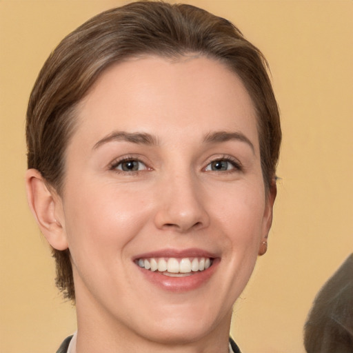 Joyful white young-adult female with short  brown hair and brown eyes