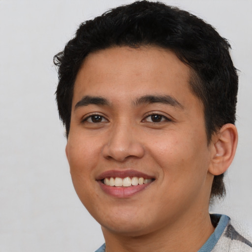 Joyful asian young-adult male with short  black hair and brown eyes