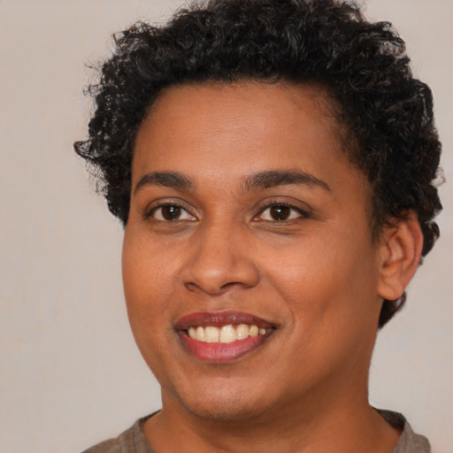 Joyful black young-adult female with short  brown hair and brown eyes
